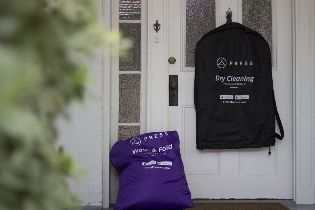 Press laundry and dry cleaning bag on doorstep